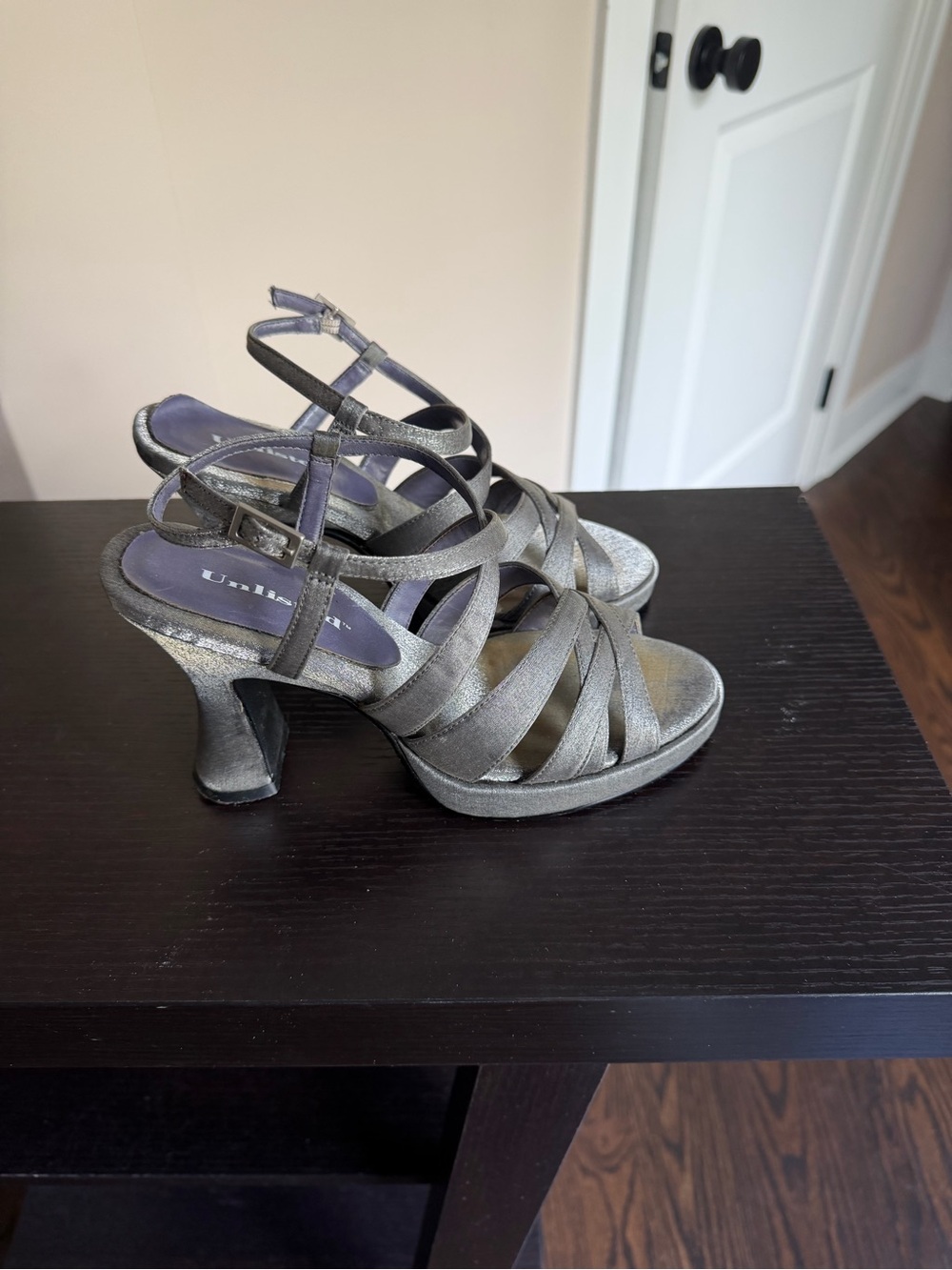 Unlisted metallic gray strappy heels with an ankle strap and a flared heel